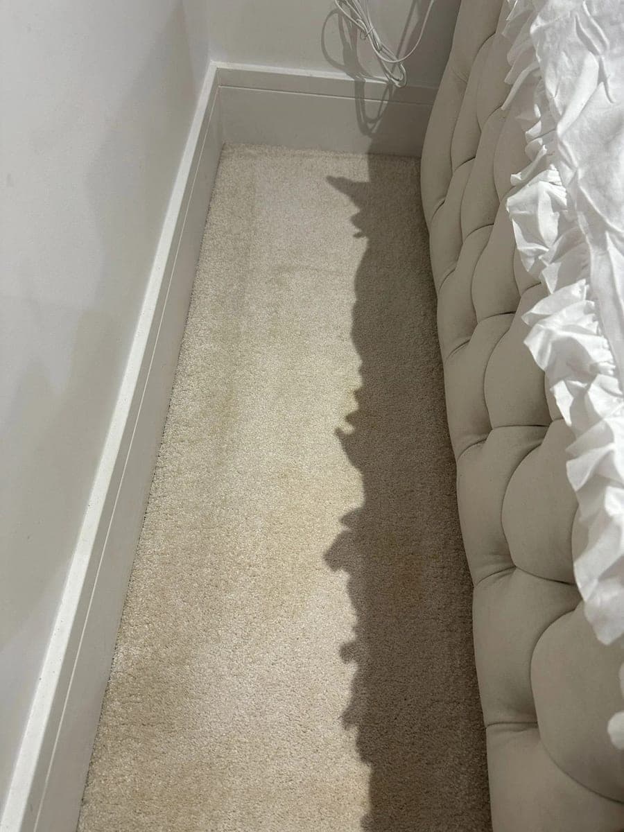 Bedroom carpet beside a bed, heavily stained before cleaning and clean, even fibers afterwards